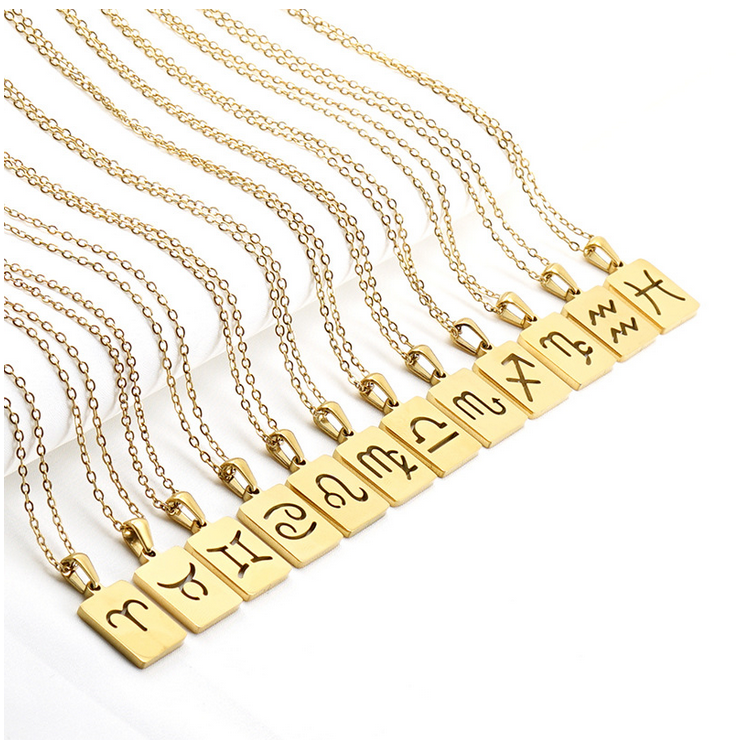 A gold necklace with a dainty chain. The necklace has a rectangular pendat that is attached to the necklace with a loop. The pendant has the astrological symbols carved out of the pendant.  The necklaces are in order of the astrological ecliptic and are lined up against a white background. 