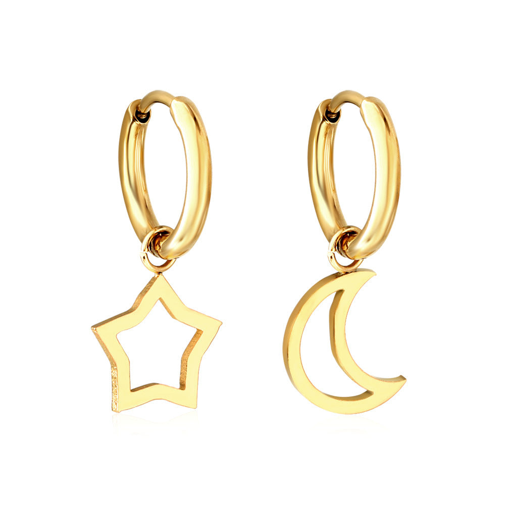 Asymmetrical gold earrings. One earring has a hollow star and the other has a hollow crescent moon. The charms are connected to a small hoop that is also gold. 