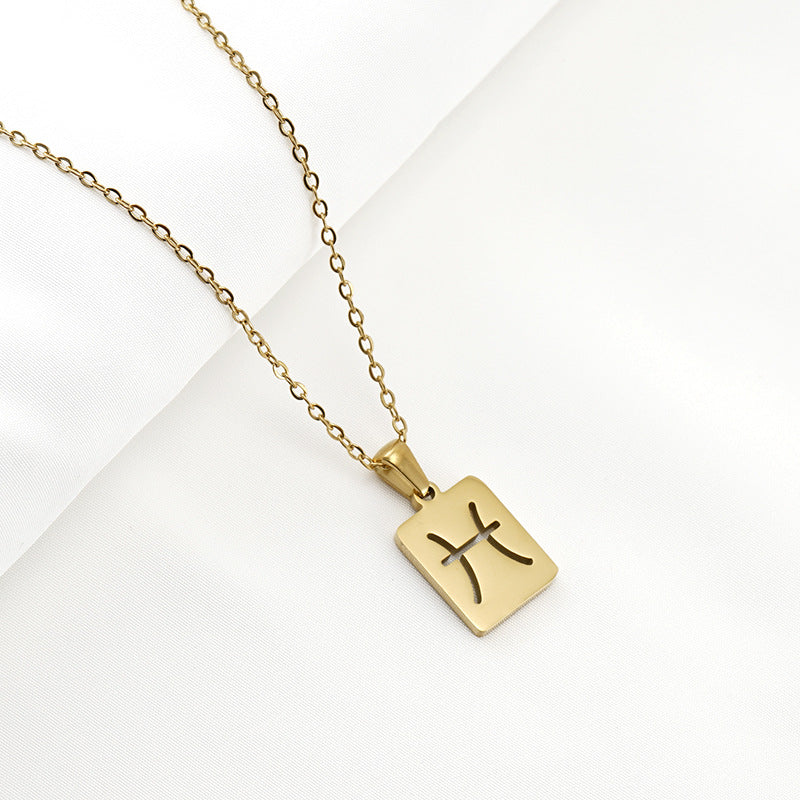 A gold necklace with a dainty chain and rectangular pendant in the Pisces style. 