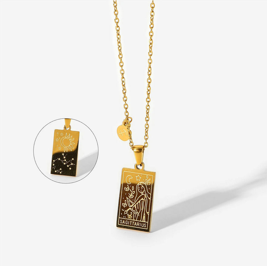 A gold necklace with a dainty chain. The necklace has a two-sided pendant in the Sagittarius style. The front side displays the animal which represents the zodiac in laser etching with the sign spelled out in capital letters. The reverse is shown as a picture in picture image. The reverse is in the style of the astrological constellation. There is also a small circular charm with the zodiac symbol approximately one inch above the pendant.