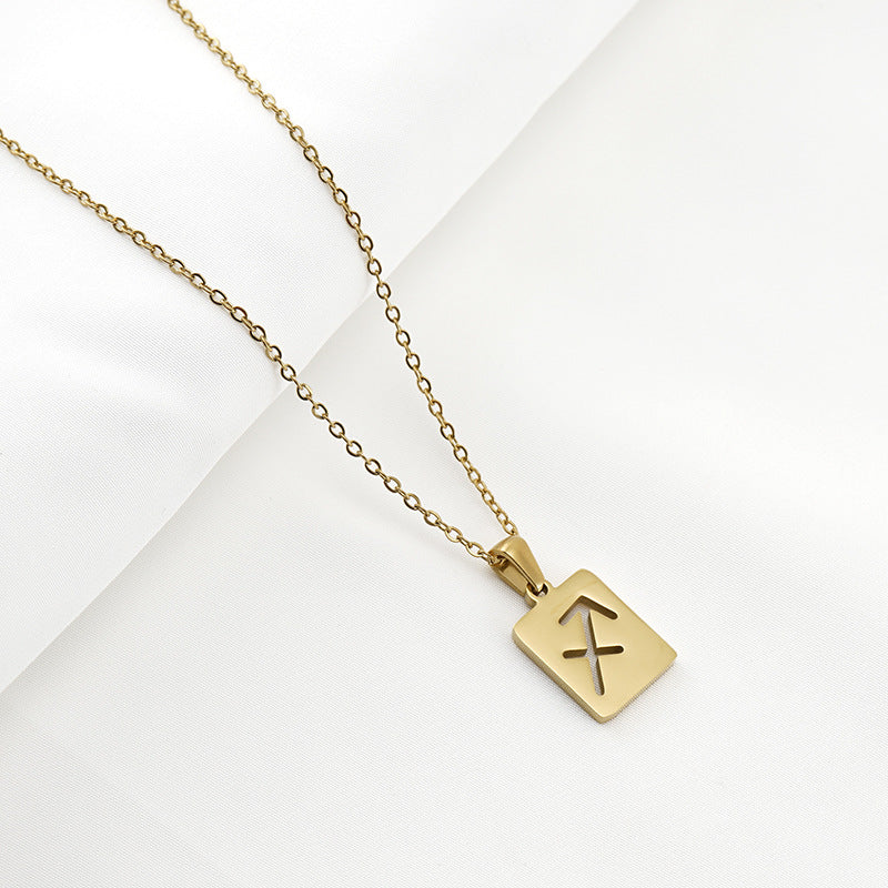 A gold necklace with a dainty chain and rectangular pendant in the Sagittarius style. 