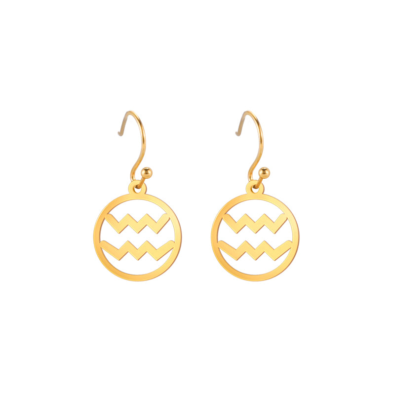 Gold earrings with the astrological symbol for Aquarius. The zodiac earrings are suspended in the air with a white background.