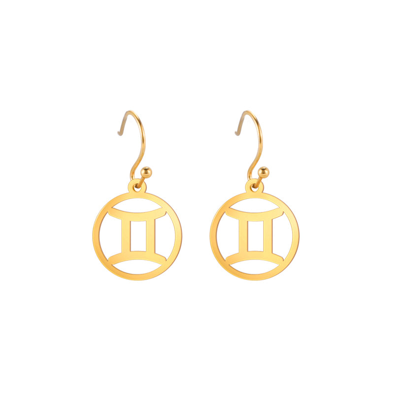 Gold earrings with the astrological symbol for Gemini. The zodiac earrings are suspended in the air with a white background.