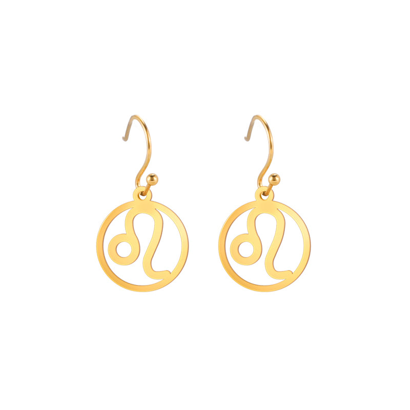 Gold earrings with the astrological symbol for Leo. The zodiac earrings are suspended in the air with a white background.