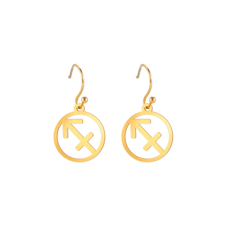 Gold earrings with the astrological symbol for Sagittarius. The zodiac earrings are suspended in the air with a white background.