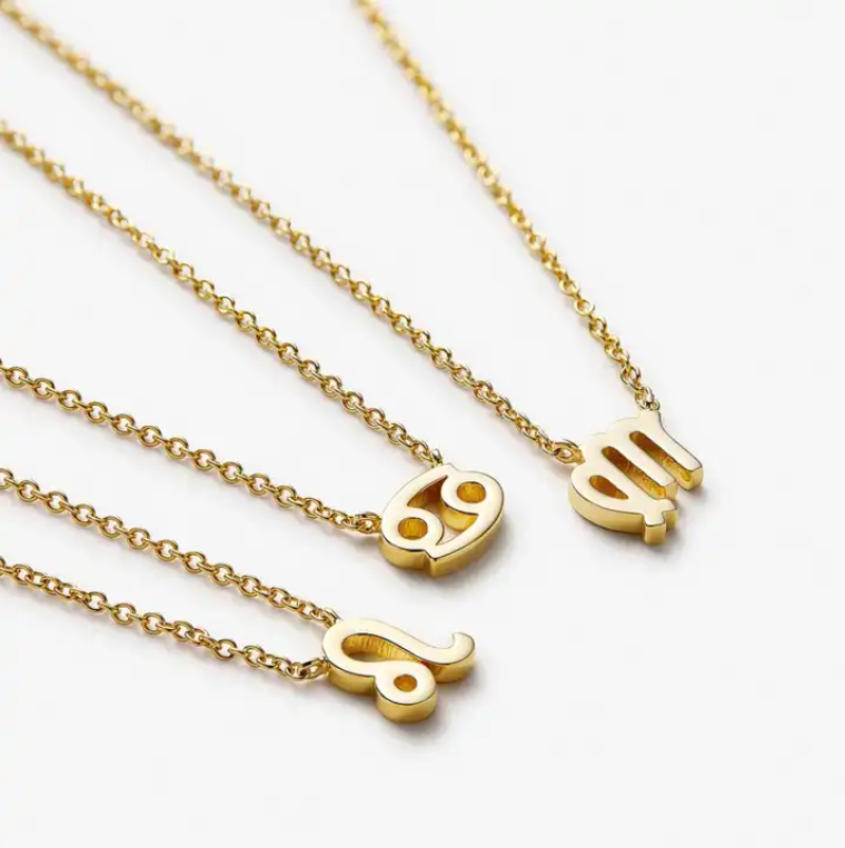 The gold-plated zodiac inspired Aspect necklace shown in the Leo, Cancer, and Virgo style. 