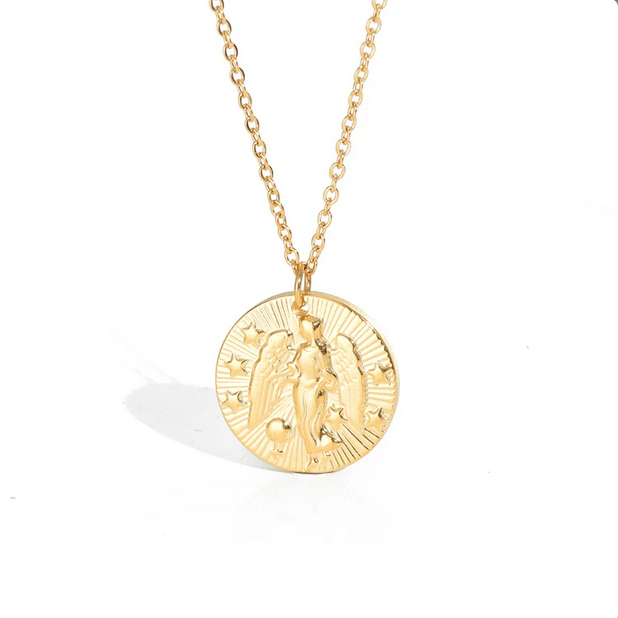 A gold necklace with a dainty chain. The necklace has a coin pendant displaying the astrological sign Virgo of the zodiac.